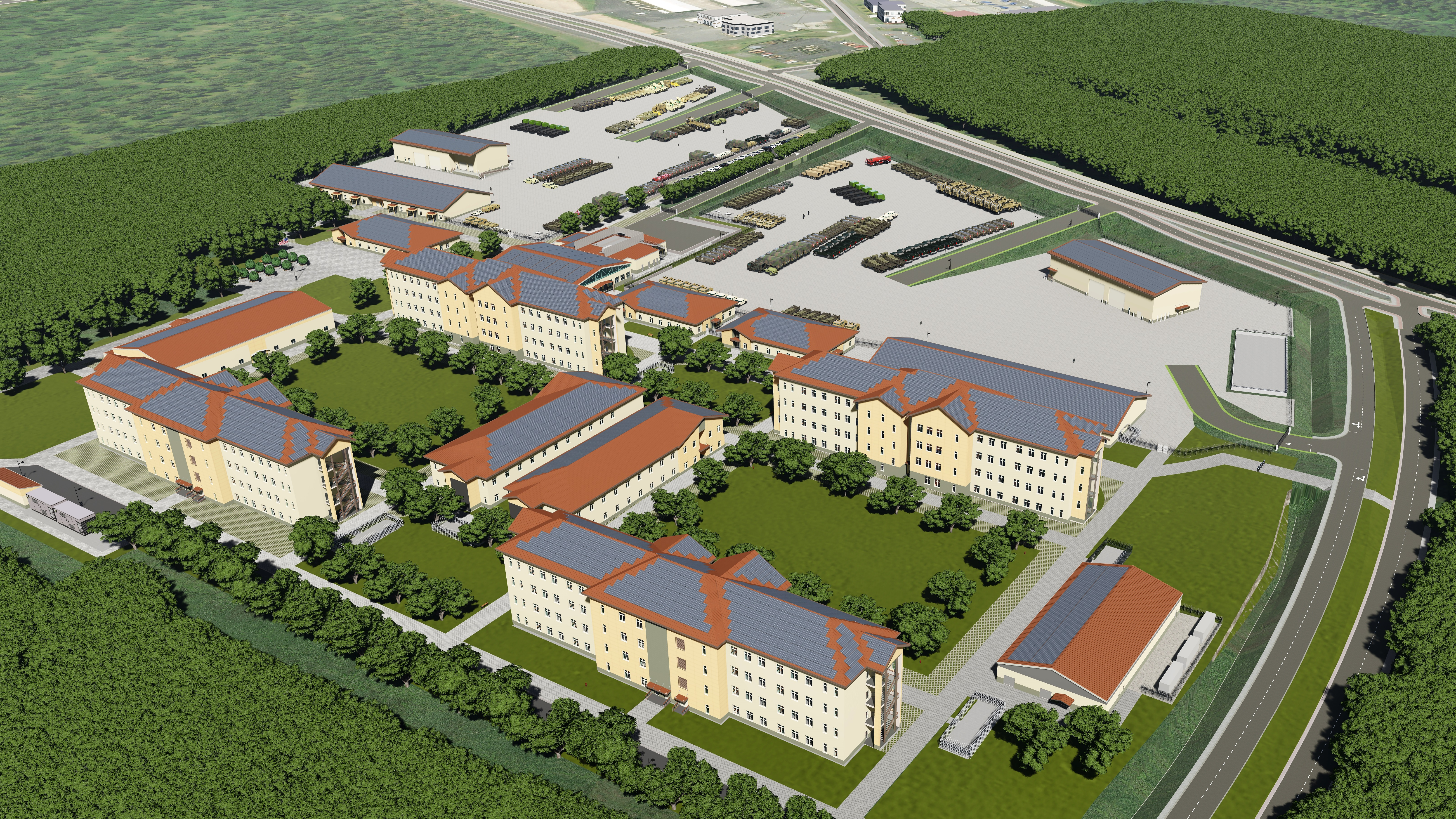 Aerial view of a large complex with multiple beige buildings, red roofs, green lawns, and surrounding forests.